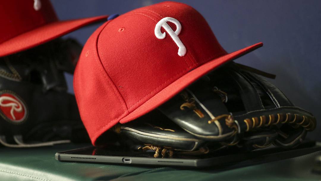 May 25, 2022; Atlanta, Georgia, USA; Detailed view of a Philadelphia Phillies hat and glove in the dugout against the Atlanta Braves in the eighth inning at Truist Park. May 25, 2022; Atlanta, Georgia, USA; Detailed view of a Philadelphia Phillies hat and glove in the dugout against the Atlanta Braves in the eighth inning at Truist Park.