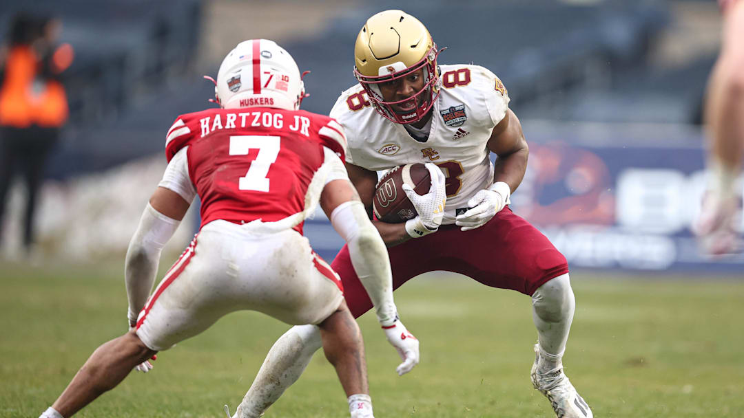 Dec 28, 2024; Bronx, NY, USA; Boston College Eagles wide receiver Johnathan Montague Jr. (8) is tackled by Nebraska Cornhuskers defensive back Malcolm Hartzog Jr. (7) during the first half at Yankee Stadium. Mandatory Credit: Vincent Carchietta-Imagn Images