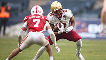 Dec 28, 2024; Bronx, NY, USA; Boston College Eagles wide receiver Johnathan Montague Jr. (8) is tackled by Nebraska Cornhuskers defensive back Malcolm Hartzog Jr. (7) during the first half at Yankee Stadium. Mandatory Credit: Vincent Carchietta-Imagn Images