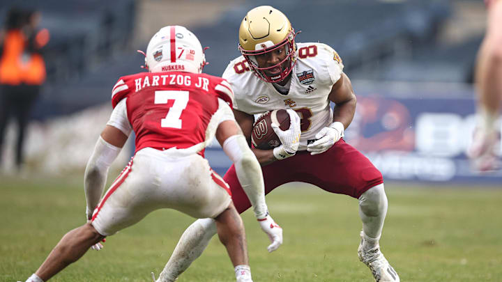 Dec 28, 2024; Bronx, NY, USA; Boston College Eagles wide receiver Johnathan Montague Jr. (8) is tackled by Nebraska Cornhuskers defensive back Malcolm Hartzog Jr. (7) during the first half at Yankee Stadium. Mandatory Credit: Vincent Carchietta-Imagn Images