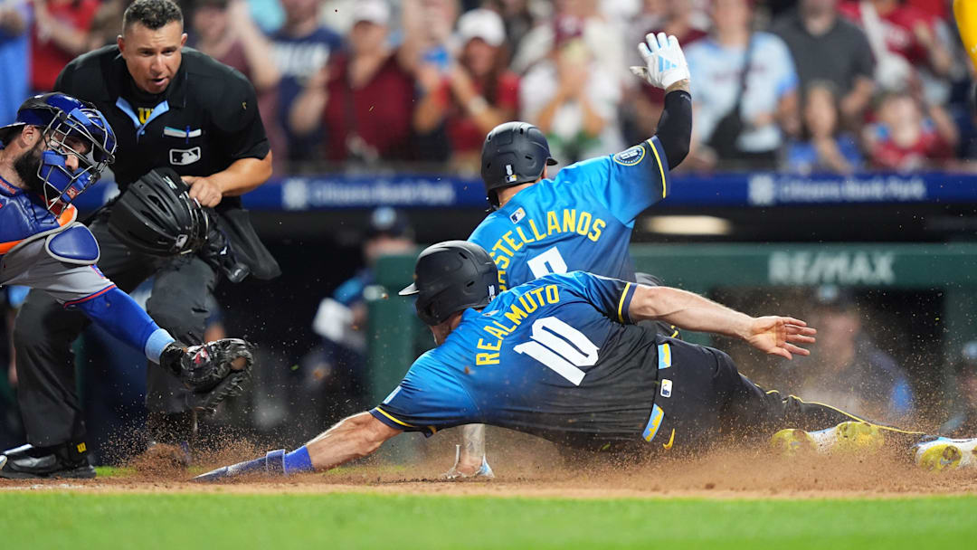 Jun 20, 2025; Philadelphia, Pennsylvania, USA; Philadelphia Phillies catcher J.T. Realmuto (10) and outfielder Nick Castellanos (8) advance home to score against the New York Mets in the seventh inning at Citizens Bank Park. Mandatory Credit: Kyle Ross-Imagn Images