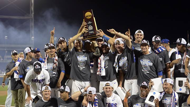 Jun 27, 2017; Omaha, NE, USA; Florida Gators players and coaches celebrate with the national championship trophy after the game against the LSU Tigers in game two of the championship series of the 2017 College World Series at TD Ameritrade Park Omaha. Mandatory Credit: Steven Branscombe-Imagn Images