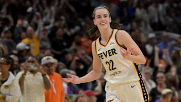 May 24, 2024; Los Angeles, California, USA;  Indiana Fever guard Caitlin Clark (22) smiles as she heads down court after a 3-point basket in the final seconds of the game against the Los Angeles Sparks at Crypto.com Arena. Mandatory Credit: Jayne Kamin-Oncea-Imagn Images