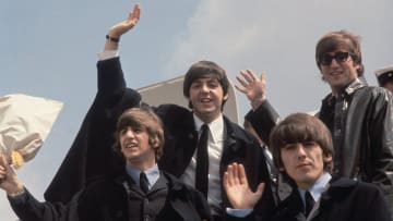 Beatles board a plane