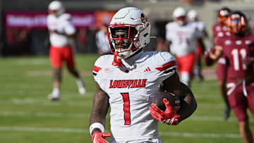 Nov 1, 2025; Blacksburg, Virginia, USA;  Louisville Cardinals running back Isaac Brown (1) reacts after scoring a touchdown against the Virginia Tech Hokies during the first quarter at Lane Stadium. Mandatory Credit: Brian Bishop-Imagn Images