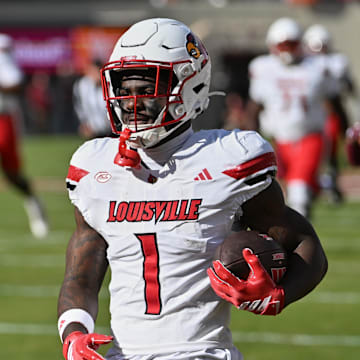 Nov 1, 2025; Blacksburg, Virginia, USA;  Louisville Cardinals running back Isaac Brown (1) reacts after scoring a touchdown against the Virginia Tech Hokies during the first quarter at Lane Stadium. Mandatory Credit: Brian Bishop-Imagn Images