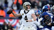 Dec 8, 2024; East Rutherford, New Jersey, USA; New Orleans Saints quarterback Derek Carr (4) drops back to pass against the New York Giants during the third quarter at MetLife Stadium. Mandatory Credit: Brad Penner-Imagn Images