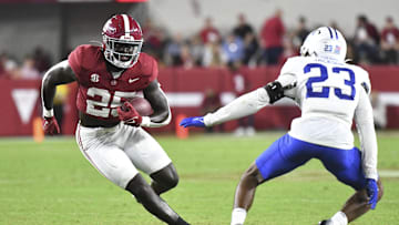 Sep 2, 2023; Tuscaloosa, Alabama, USA; Alabama Crimson Tide running back Richard Young (25)  runs the ball against Middle Tennessee Blue Raiders cornerback Jalen Jackson (23) during the second half at Bryant-Denny Stadium. Alabama won 56-7. Mandatory Credit: Gary Cosby Jr.-USA TODAY Sports