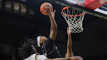 Feb 8, 2025; Columbia, Missouri, USA; Texas A&M Aggies guard Zhuric Phelps (1) shoots against Missouri Tigers guard Anthony Robinson II (0) and guard Tony Perkins (12) during the second half at Mizzou Arena. Mandatory Credit: Jay Biggerstaff-Imagn Images