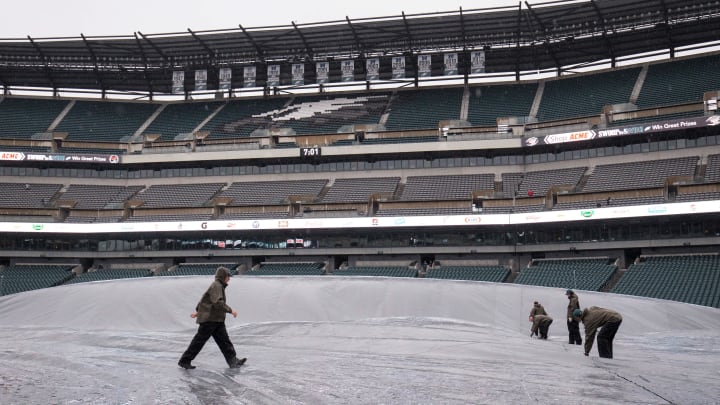 Oct 29, 2017; Philadelphia, PA, USA; Grounds crew maintain the rain tarp on Lincoln Financial Field