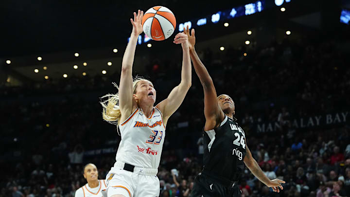 Oct 3, 2025; Las Vegas, Nevada, USA; Las Vegas Aces guard Jewell Loyd (24) looks to tip a loose ball away from Phoenix Mercury guard Sami Whitcomb (33) during the fourth quarter of game one of the 2025 WNBA Finals at Michelob Ultra Arena. Mandatory Credit: Stephen R. Sylvanie-Imagn Images