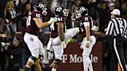 Nov 26, 2022; College Station, Texas, USA; Texas A&M Aggies quarterback Conner Weigman (15) and offensive lineman Layden Robinson (64) and offensive lineman Trey Zuhn III (60) celebrates a touchdown against the LSU Tigers during the second half at Kyle Field. Mandatory Credit: Jerome Miron-Imagn Images