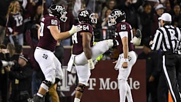 Nov 26, 2022; College Station, Texas, USA; Texas A&M Aggies quarterback Conner Weigman (15) and offensive lineman Layden Robinson (64) and offensive lineman Trey Zuhn III (60) celebrates a touchdown against the LSU Tigers during the second half at Kyle Field. Mandatory Credit: Jerome Miron-Imagn Images
