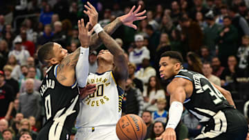 Nov 22, 2024; Milwaukee, Wisconsin, USA: Milwaukee Bucks guard Damian Lillard (0) and forward Giannis Antetokounmpo (34) put pressure on Indiana Pacers forward Bennedict Mathurin (00) in the first quarter at Fiserv Forum. Mandatory Credit: Benny Sieu-Imagn Images