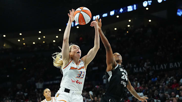Oct 3, 2025; Las Vegas, Nevada, USA; Las Vegas Aces guard Jewell Loyd (24) looks to tip a loose ball away from Phoenix Mercury guard Sami Whitcomb (33) during the fourth quarter of game one of the 2025 WNBA Finals at Michelob Ultra Arena. Mandatory Credit: Stephen R. Sylvanie-Imagn Images