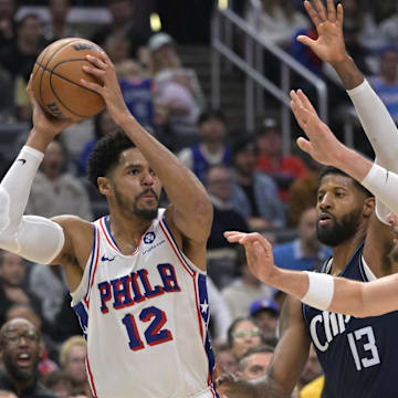 Mar 24, 2024; Los Angeles, California, USA;   Philadelphia 76ers forward Tobias Harris (12) is defended by Los Angeles Clippers forward Paul George (13) and center Ivica Zubac (40) in the second half at Crypto.com Arena. Mandatory Credit: Jayne Kamin-Oncea-Imagn Images