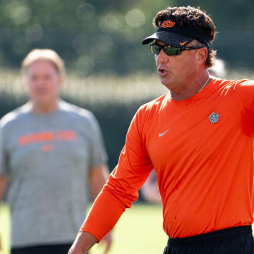 Head coach Mike Gundy walks on the field during an Oklahoma State football practice in Stillwater, Okla., on Saturday, Aug. 3, 2024.