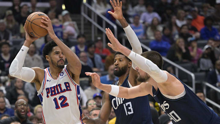 Mar 24, 2024; Los Angeles, California, USA;   Philadelphia 76ers forward Tobias Harris (12) is defended by Los Angeles Clippers forward Paul George (13) and center Ivica Zubac (40) in the second half at Crypto.com Arena. Mandatory Credit: Jayne Kamin-Oncea-Imagn Images