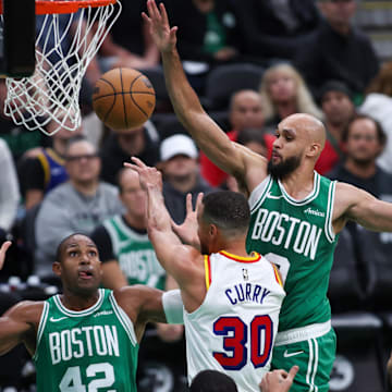 Nov 6, 2024; Boston, Massachusetts, USA; Golden State Warriors guard Stephen Curry (30) passes the ball defended by Boston Celtics guard Derrick White (9) during the first half at TD Garden. Mandatory Credit: Paul Rutherford-Imagn Images