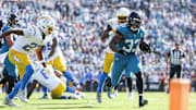 Nov 16, 2025; Jacksonville, Florida, USA; Jacksonville Jaguars running back Bhayshul Tuten (33) rushes against the Los Angeles Chargers d at EverBank Stadium. Mandatory Credit: Nathan Ray Seebeck-Imagn Images