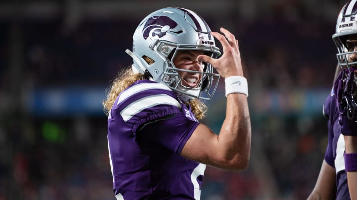 Dec 28, 2023; Orlando, FL, USA; Kansas State quarterback Avery Johnson (2) celebrates his touchdown against NC State in the second quarter at Camping World Stadium. Mandatory Credit: Jeremy Reper-USA TODAY Sports