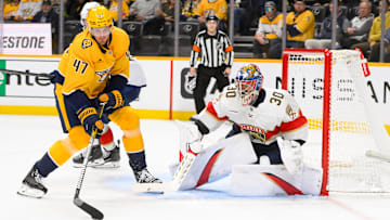 Feb 25, 2025; Nashville, Tennessee, USA;  Nashville Predators right wing Michael McCarron (47) skates with the puck and scores past Florida Panthers goaltender Spencer Knight (30) during the third half at Bridgestone Arena. Mandatory Credit: Steve Roberts-Imagn Images