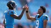 Sep 21, 2025; Charlotte, North Carolina, USA; Carolina Panthers quarterback Bryce Young (9) and wide receiver Tetairoa McMillan (4) high five before a game against the Carolina Panthers at Bank of America Stadium. Mandatory Credit: Cory Knowlton-Imagn Images