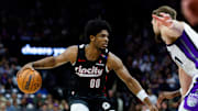 Mar 27, 2025; Sacramento, California, USA; Portland Trail Blazers guard Scoot Henderson (00) dribbles against Sacramento Kings forward Domantas Sabonis (11) during the third quarter at Golden 1 Center. Mandatory Credit: Sergio Estrada-Imagn Images