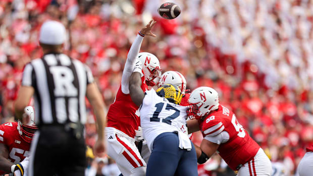 Nebraska quarterback Dylan Raiola is hit by Michigan defensive lineman Enow Etta. 