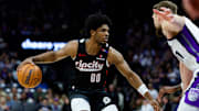 Mar 27, 2025; Sacramento, California, USA; Portland Trail Blazers guard Scoot Henderson (00) dribbles against Sacramento Kings forward Domantas Sabonis (11) during the third quarter at Golden 1 Center. Mandatory Credit: Sergio Estrada-Imagn Images