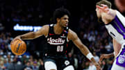 Mar 27, 2025; Sacramento, California, USA; Portland Trail Blazers guard Scoot Henderson (00) dribbles against Sacramento Kings forward Domantas Sabonis (11) during the third quarter at Golden 1 Center. Mandatory Credit: Sergio Estrada-Imagn Images