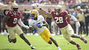Oct 11, 2025; Tallahassee, Florida, USA; Pittsburgh Panthers wide receiver Raphael Williams Jr. (5) runs the ball up the field past Florida State Seminoles linebacker Omar Graham Jr. (9) and linebacker Justin Cryer (28) during the second half at Doak S. Campbell Stadium. Mandatory Credit: Melina Myers-Imagn Images
