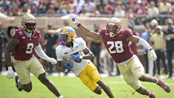 Oct 11, 2025; Tallahassee, Florida, USA; Pittsburgh Panthers wide receiver Raphael Williams Jr. (5) runs the ball up the field past Florida State Seminoles linebacker Omar Graham Jr. (9) and linebacker Justin Cryer (28) during the second half at Doak S. Campbell Stadium. Mandatory Credit: Melina Myers-Imagn Images
