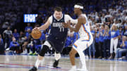 Dallas Mavericks guard Luka Doncic (77) drives to the basket around Oklahoma City Thunder guard Shai Gilgeous-Alexander.