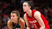 Jul 6, 2024; Indianapolis, Indiana, USA; New York Liberty guard Sabrina Ionescu (20) and Indiana Fever guard Caitlin Clark (22) watch a free throw at Gainbridge Fieldhouse. Mandatory Credit: Grace Smith/INDIANAPOLIS STAR-USA TODAY Sports