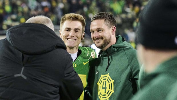  Oregon Ducks quarterback Bo Nix (10) and head coach Dan Lanning have their picture taken before a game against the Oregon St