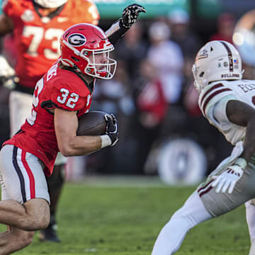 Oct 12, 2024; Athens, Georgia, USA; Georgia Bulldogs running back Cash Jones (32) runs against Mississippi State Bulldogs safety Corey Ellington (10) at Sanford Stadium. Mandatory Credit: Dale Zanine-Imagn Images