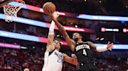 Mar 14, 2025; Houston, Texas, USA; Houston Rockets guard Jalen Green (4) shoots against Dallas Mavericks forward Kessler Edwards (20) in the first half at Toyota Center. Mandatory Credit: Thomas Shea-Imagn Images