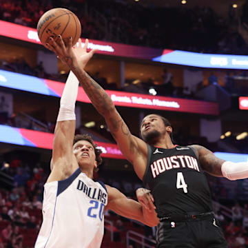 Mar 14, 2025; Houston, Texas, USA; Houston Rockets guard Jalen Green (4) shoots against Dallas Mavericks forward Kessler Edwards (20) in the first half at Toyota Center. Mandatory Credit: Thomas Shea-Imagn Images