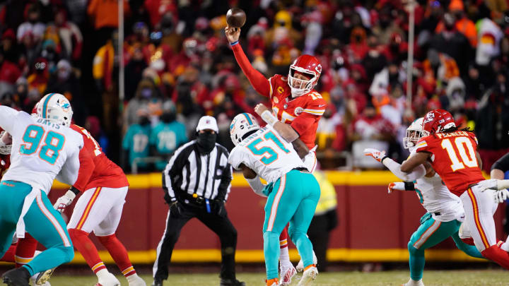 Jan 13, 2024; Kansas City, Missouri, USA; Kansas City Chiefs quarterback Patrick Mahomes (15) throws under pressure from Miami Dolphins linebacker David Long Jr. (51) during the first half of the 2024 AFC wild card game at GEHA Field at Arrowhead Stadium.