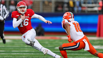 Nov 23, 2024; Piscataway, New Jersey, USA; Rutgers Scarlet Knights quarterback Athan Kaliakmanis (16) carries the ball as Illinois Fighting Illini defensive back Miles Scott (10) pursues during the first half at SHI Stadium. Mandatory Credit: Vincent Carchietta-Imagn Images