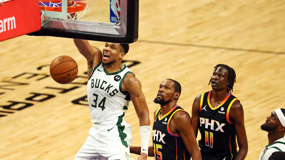 Phoenix Suns' Kevin Durant watches as Milwaukee Bucks' Giannis Antetokounmpo throws down a dunk. | Mark J. Rebilas-Imagn Images