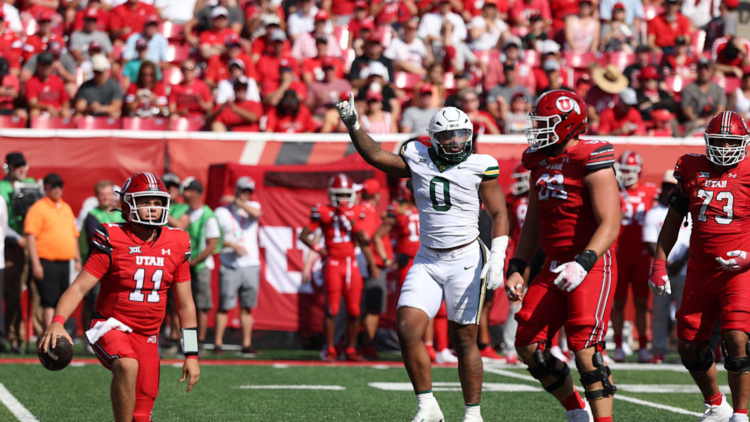 Sep 7, 2024; Salt Lake City, Utah, USA; Baylor Bears defensive lineman Jackie Marshall (0) reacts to a sack on Utah Utes quarterback Isaac Wilson (11) during the third quarter at Rice-Eccles Stadium. Mandatory Credit: Rob Gray-Imagn Images