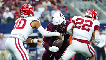 Sep 28, 2024; Arlington, Texas, USA; Texas A&M Aggies defensive lineman Shemar Stewart (4) causes a fumble between Arkansas Razorbacks quarterback Taylen Green (10) and Arkansas Razorbacks running back Ja'Quinden Jackson (22) during the first half at AT&T Stadium. Mandatory Credit: Kevin Jairaj-Imagn Images
