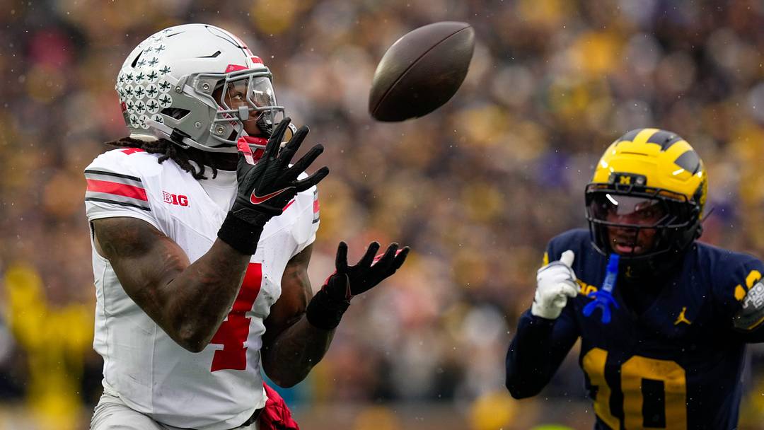 Ohio State Buckeyes wide receiver Jeremiah Smith (4) catches a pass against the Michigan Wolverines in the first half of the NCAA football game at Michigan Stadium on Saturday, Nov. 29, 2025 in Ann Arbor, Michigan.