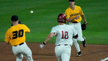 Apr 25, 2025; Tuscaloosa, AL, USA; Missouri first baseman Jackson Lovich fields a ball and flips it to the pitcher Wil Libbert who is covering as Alabama batter Will Hodo is too late at first at Sewell-Thomas Stadium Friday night.