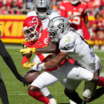 Oct 19, 2025; Kansas City, Missouri, USA; Kansas City Chiefs wide receiver Marquise Brown (5) fumbles defended by Las Vegas Raiders safety Jeremy Chinn (11) during the third quarter of the game at GEHA Field at Arrowhead Stadium. Mandatory Credit: Denny Medley-Imagn Images