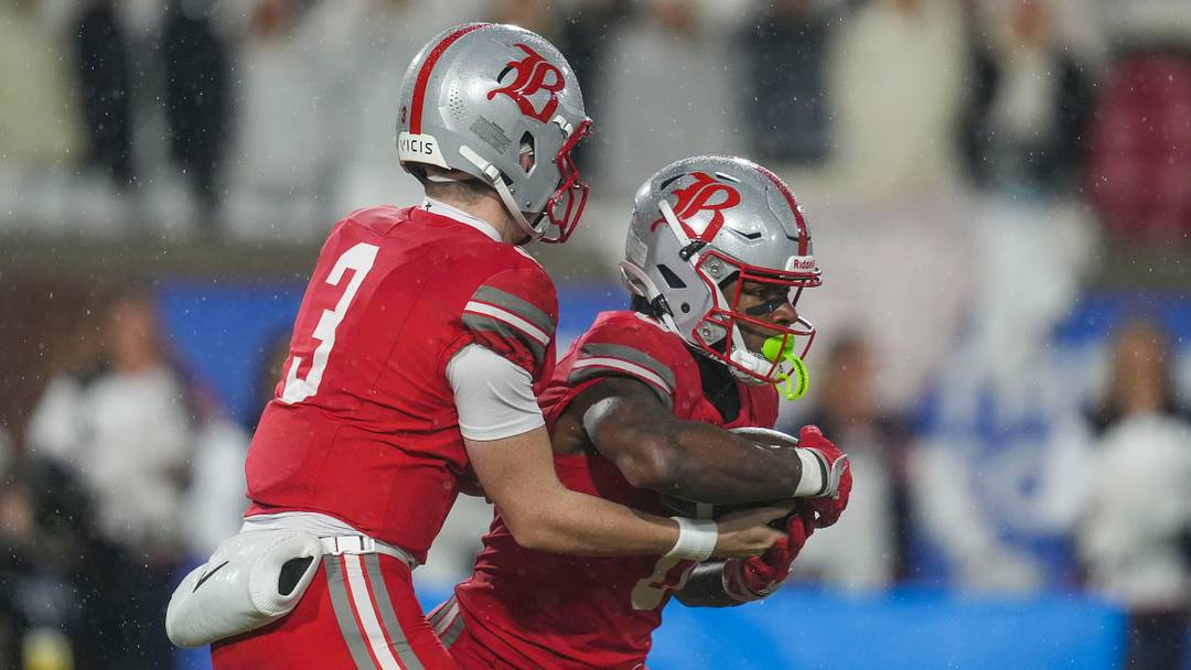 Baylor's Briggs Cherry (3) gives the ball to Baylor's David Gabriel Georges (0) during the Division II-AAA championship game at Finley Stadium in Chattanooga, Tenn., on Dec. 4, 2025.