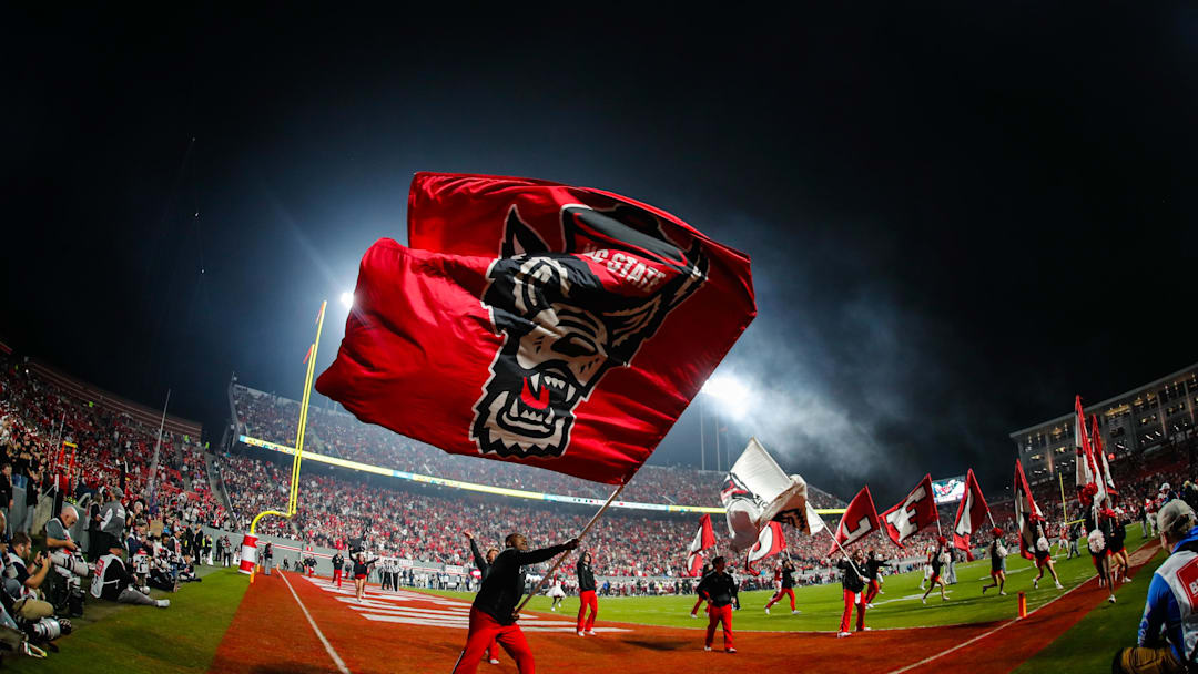 Nov 21, 2025; Raleigh, North Carolina, USA;  NC State Wolfpack cheerleader celebrates a touchdown during the second half of the game against Florida State Seminoles at Carter-Finley Stadium. Mandatory Credit: Jaylynn Nash-Imagn Images