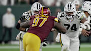 Green Bay Packers center Elgton Jenkins (74) blocks Washington Commanders defensive tackle Eddie Goldman (97) during the fourth quarter of their game Thursday, September 11, 2025 at Lambeau Field in Green Bay, Wisconsin. The Green Bay Packers beat the Washington Commanders 27-18.